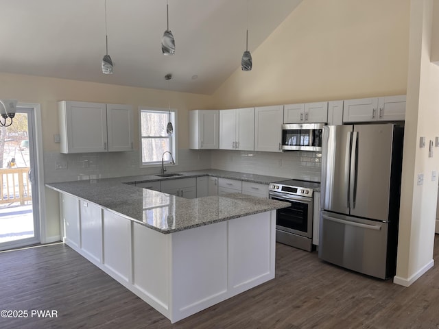 kitchen with light stone countertops, appliances with stainless steel finishes, and white cabinets