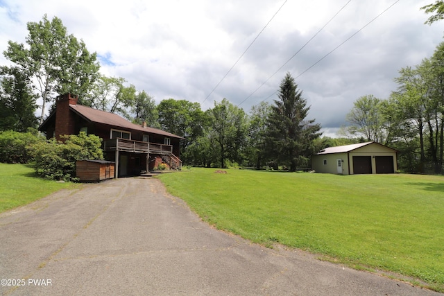 44 Purdytown Tpke, Lake Ariel, PA 18436 - view of front of property featuring a front lawn, a chimney, a detached garage, a wooden deck, and driveway