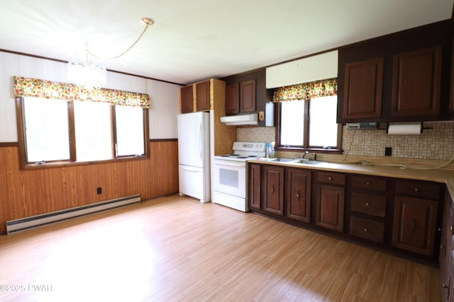 44 Purdytown Tpke, Lake Ariel, PA 18436 - kitchen with a baseboard radiator, white appliances, light countertops, wooden walls, and decorative backsplash