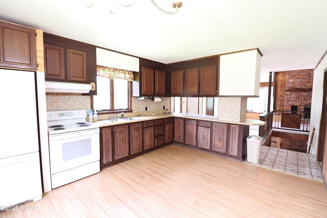 44 Purdytown Tpke, Lake Ariel, PA 18436 - kitchen featuring white appliances, decorative backsplash, light countertops, and light wood finished floors