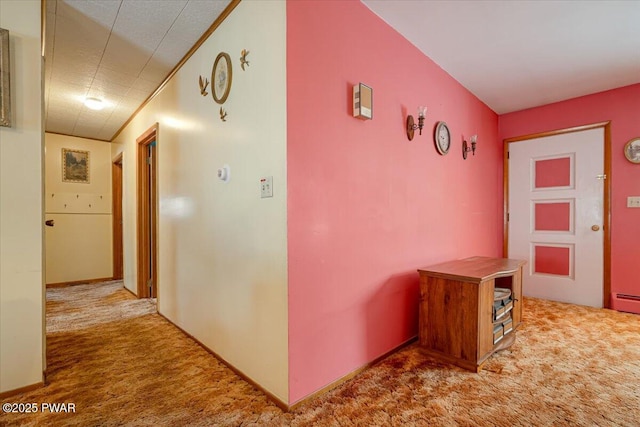 hallway with ornamental molding and carpet flooring