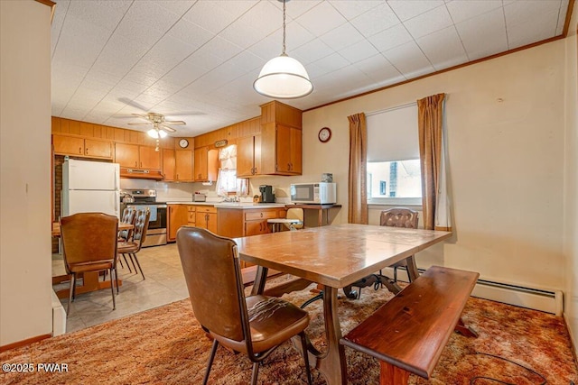 dining room with sink, ornamental molding, light tile patterned floors, ceiling fan, and baseboard heating