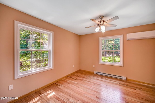 1202 Wallenpaupack Dr, Lake Ariel, PA 18436 - unfurnished room featuring a baseboard heating unit, a wall mounted AC, healthy amount of natural light, and light wood-type flooring