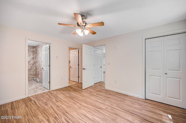 unfurnished bedroom featuring a baseboard heating unit, ensuite bathroom, ceiling fan, and light hardwood / wood-style floors