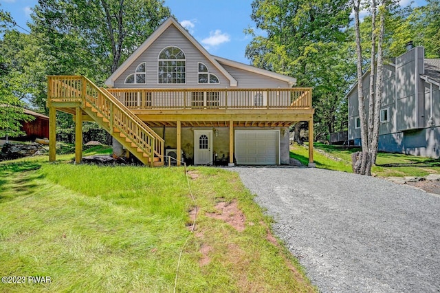 front of property featuring a front yard, a deck, and a garage