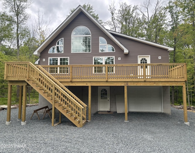 1202 Wallenpaupack Dr, Lake Ariel, PA 18436 - rear view of property featuring an attached garage, stairway, a deck, and driveway