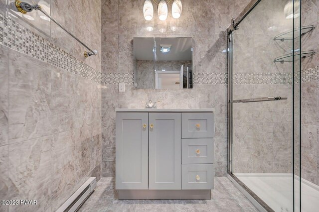 1202 Wallenpaupack Dr, Lake Ariel, PA 18436 - full bathroom featuring a shower stall, vanity, tile walls, a baseboard radiator, and a chandelier