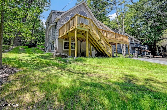 rear view of house featuring a wooden deck