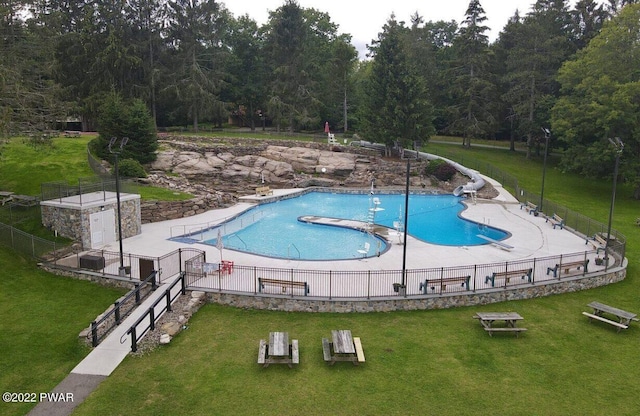 view of pool featuring a yard and a water slide