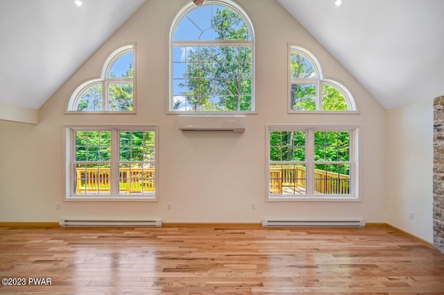 1202 Wallenpaupack Dr, Lake Ariel, PA 18436 - unfurnished living room featuring a baseboard heating unit, high vaulted ceiling, wood finished floors, and baseboards