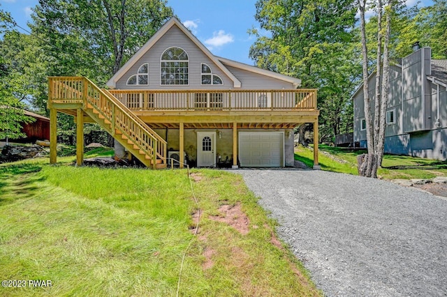 1202 Wallenpaupack Dr, Lake Ariel, PA 18436 - view of front facade featuring a garage, stairway, a wooden deck, gravel driveway, and a front lawn