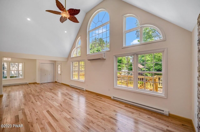 unfurnished living room with light hardwood / wood-style floors, high vaulted ceiling, ceiling fan, and a baseboard heating unit