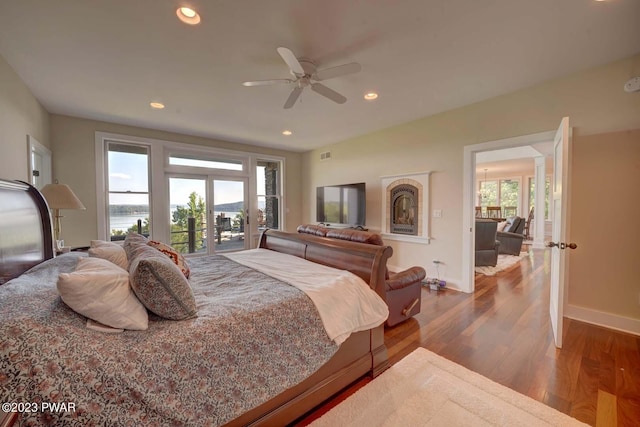 bedroom with access to outside, ceiling fan, and hardwood / wood-style flooring