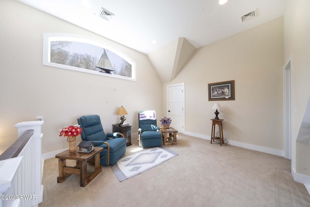 sitting room featuring light colored carpet and vaulted ceiling