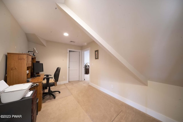 carpeted office space featuring lofted ceiling