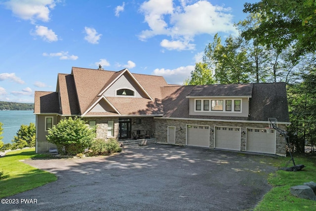 view of front facade featuring a water view and a garage