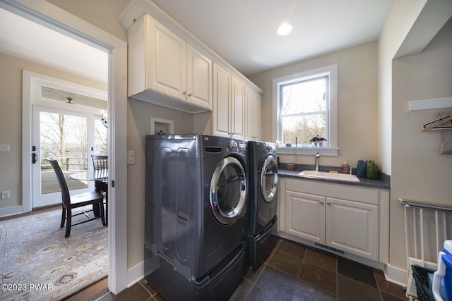 laundry room with washer and dryer, sink, and cabinets