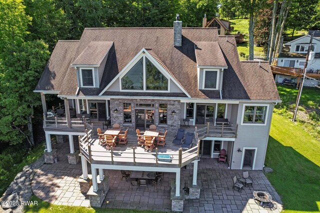 rear view of house with a yard, a patio area, and a wooden deck