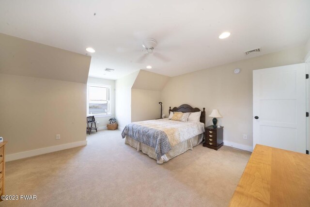 bedroom with ceiling fan, light carpet, and vaulted ceiling