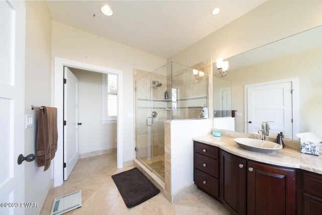 bathroom with tile patterned flooring, vanity, and an enclosed shower