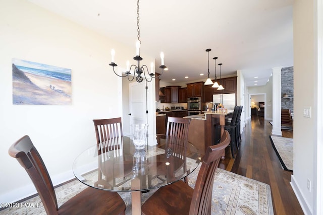 dining space featuring a chandelier and dark hardwood / wood-style flooring