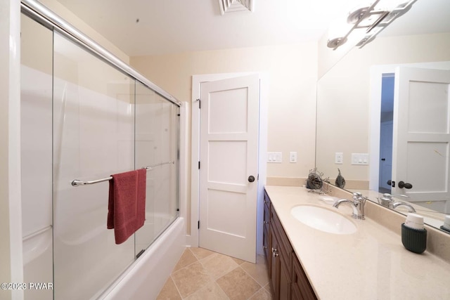 bathroom featuring tile patterned flooring, vanity, and shower / bath combination with glass door