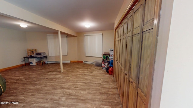 216 Westfall Dr, Dingmans Ferry, PA 18328 - finished basement featuring baseboard heating, light wood finished floors, and baseboards