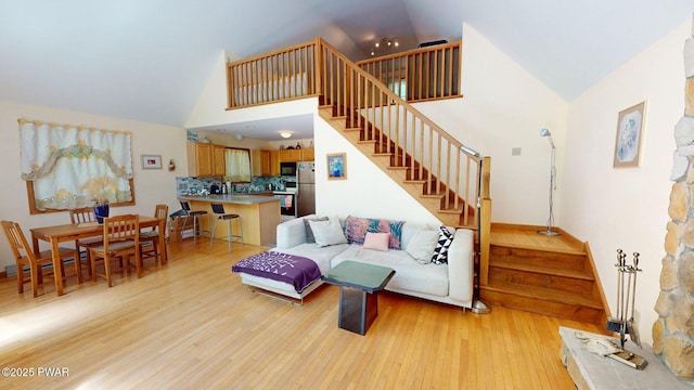 216 Westfall Dr, Dingmans Ferry, PA 18328 - living area featuring stairs, light wood-type flooring, and high vaulted ceiling