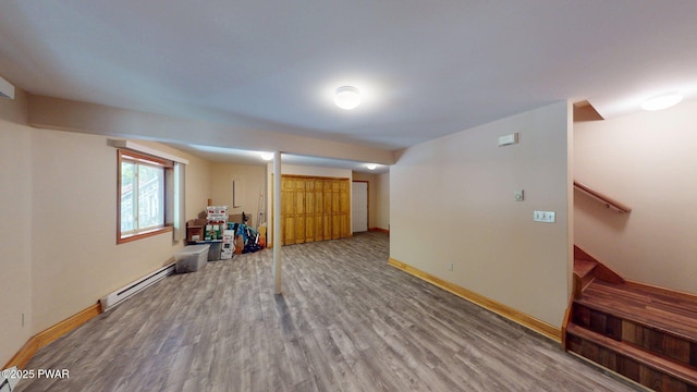 216 Westfall Dr, Dingmans Ferry, PA 18328 - below grade area with baseboard heating, wood finished floors, baseboards, and stairway
