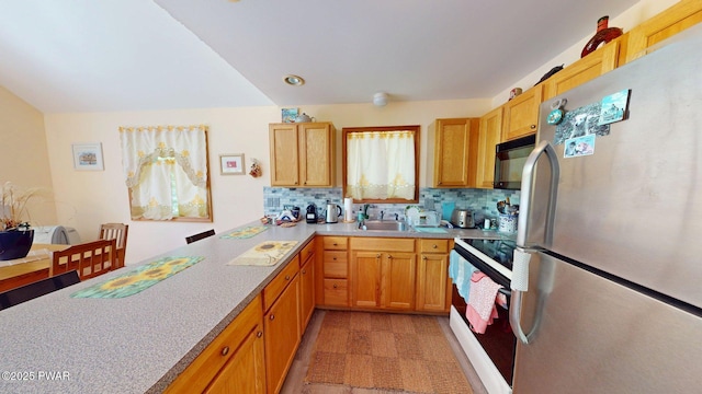 216 Westfall Dr, Dingmans Ferry, PA 18328 - kitchen with freestanding refrigerator, white electric stove, black microwave, light countertops, and backsplash