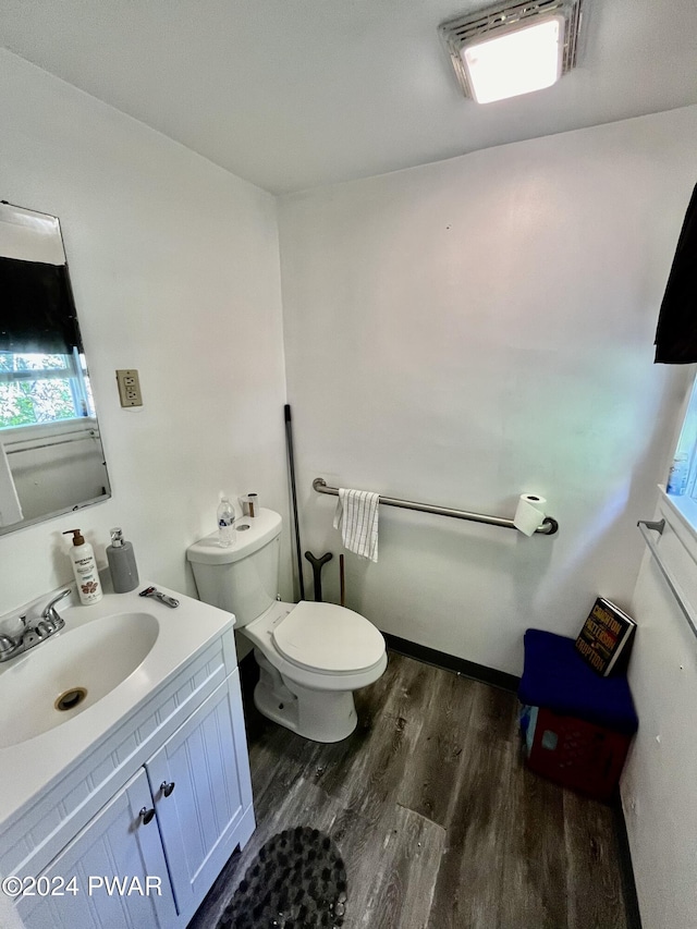 bathroom featuring hardwood / wood-style floors, vanity, and toilet