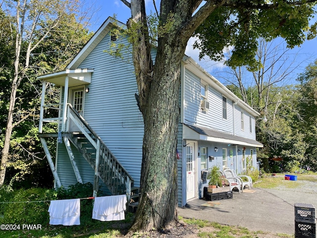 exterior space with cooling unit and a patio