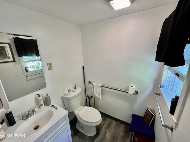 bathroom featuring hardwood / wood-style floors, vanity, and toilet