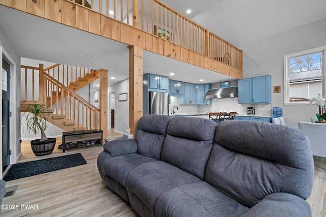 111 Riverbend Ln, Beach Lake, PA 18405 - living area featuring baseboards, a high ceiling, light wood-style floors, recessed lighting, and stairs