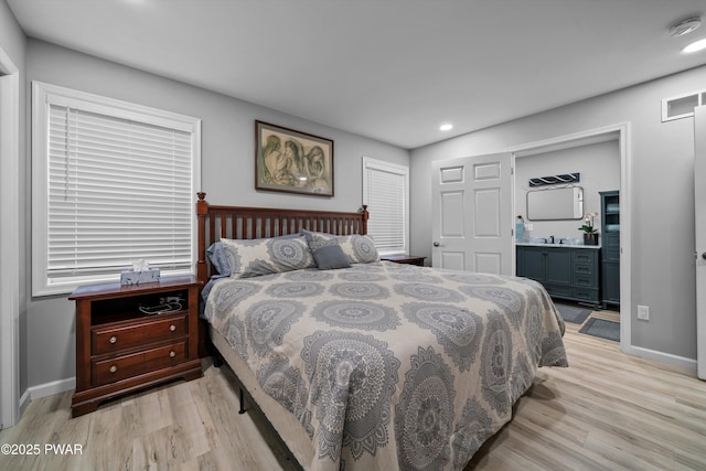 111 Riverbend Ln, Beach Lake, PA 18405 - bedroom with light wood-style floors, visible vents, recessed lighting, a sink, and baseboards