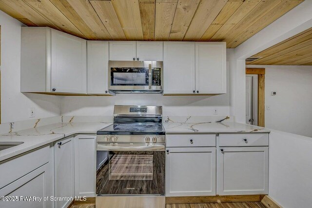28 Holland Rd, Hawley, PA 18428 - kitchen featuring stainless steel appliances, wood ceiling, white cabinetry, and light stone counters
