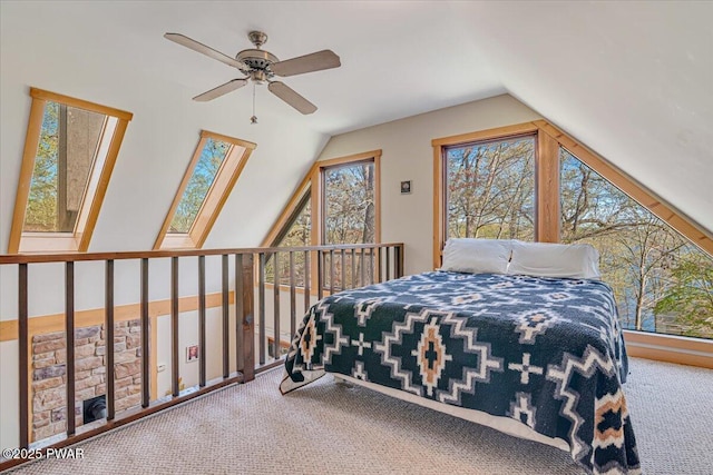 bedroom with carpet flooring, vaulted ceiling, and multiple windows