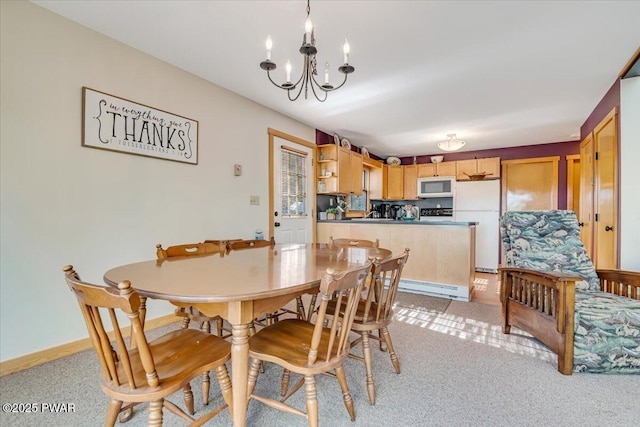 dining area with an inviting chandelier, baseboard heating, and light colored carpet