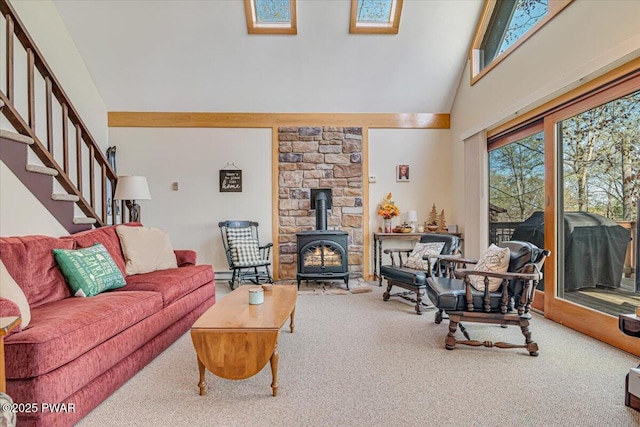 living area with a wood stove, stairway, high vaulted ceiling, and carpet