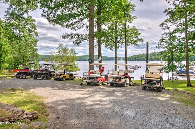 view of parking / parking lot featuring a water view