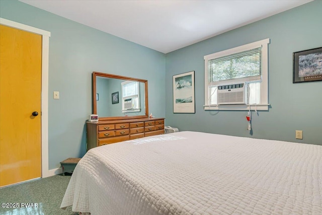 carpeted bedroom featuring baseboards and cooling unit