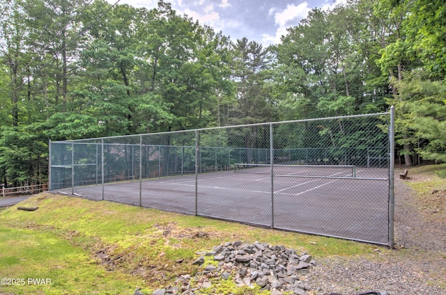 view of tennis court with fence