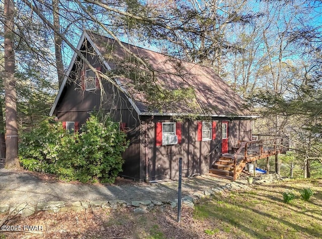 exterior space featuring roof with shingles