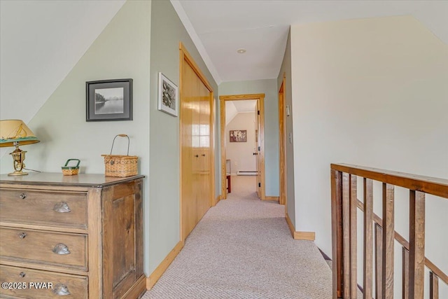 hallway with baseboards and light carpet