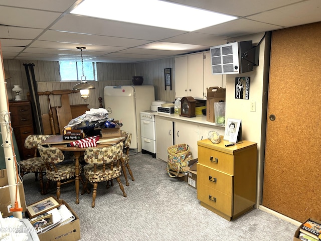 kitchen featuring light carpet, light countertops, and a paneled ceiling