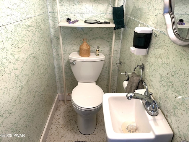 bathroom with toilet and a sink