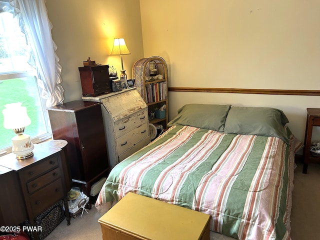 bedroom with multiple windows and carpet