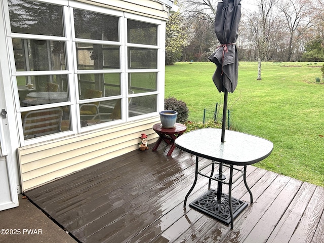 wooden terrace featuring a lawn