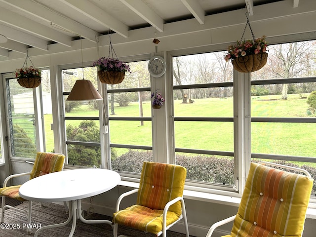 sunroom / solarium with beam ceiling and a wealth of natural light