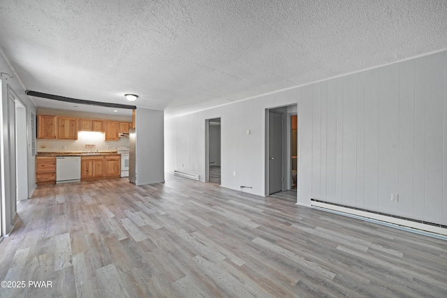 unfurnished living room with light wood-style flooring, a textured ceiling, and a baseboard heating unit